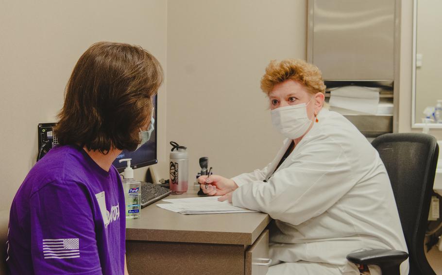 Dr. Liza Pilch, a medical provider at the Military Entrance Processing Command in Chicago, conducts a medical evaluation with an applicant in November 2021.