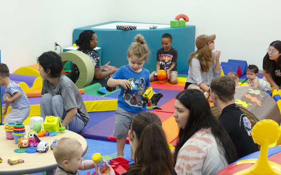 Women playing with their children.