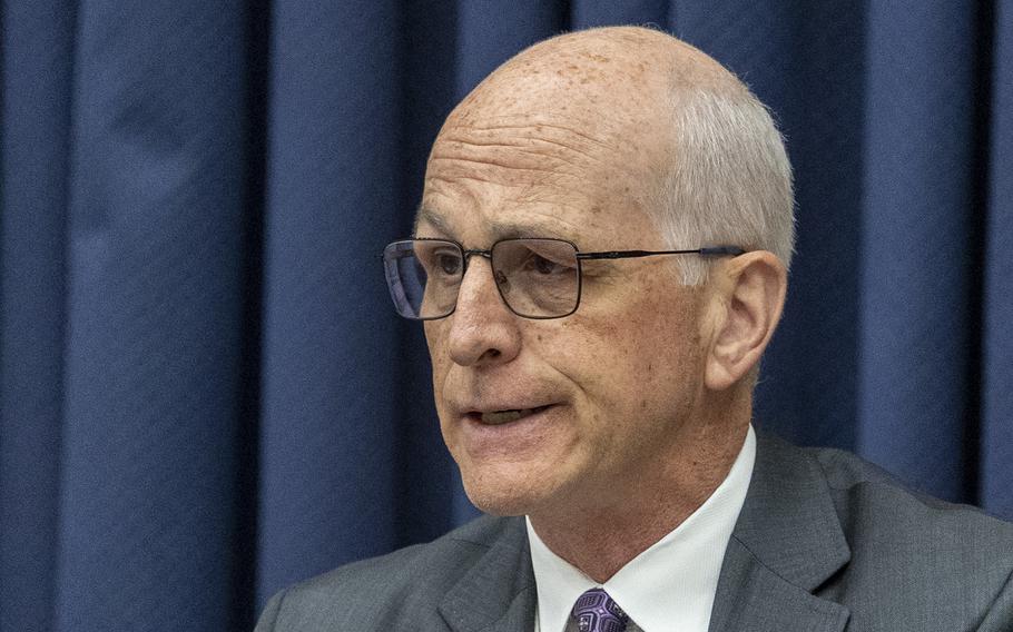 Smith seated at the hearing and making a comment.