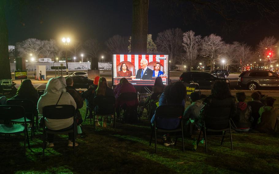 Activists watch President Joe Biden’s State of the Union address near the U.S. Capitol on March 1, 2022. 