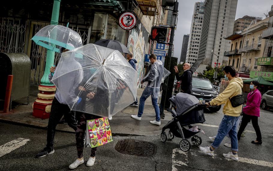 Rain drenches streets in Chinatown in San Francisco, on Sept. 18, 2022. The rainstorm is a dramatic shift of events for many residents after a record heat wave and grueling wildfire season. 