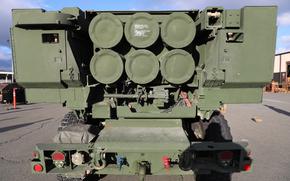 The back of a vehicle carrying a mounted High Mobility Artillery Rocket System or HIMARS.