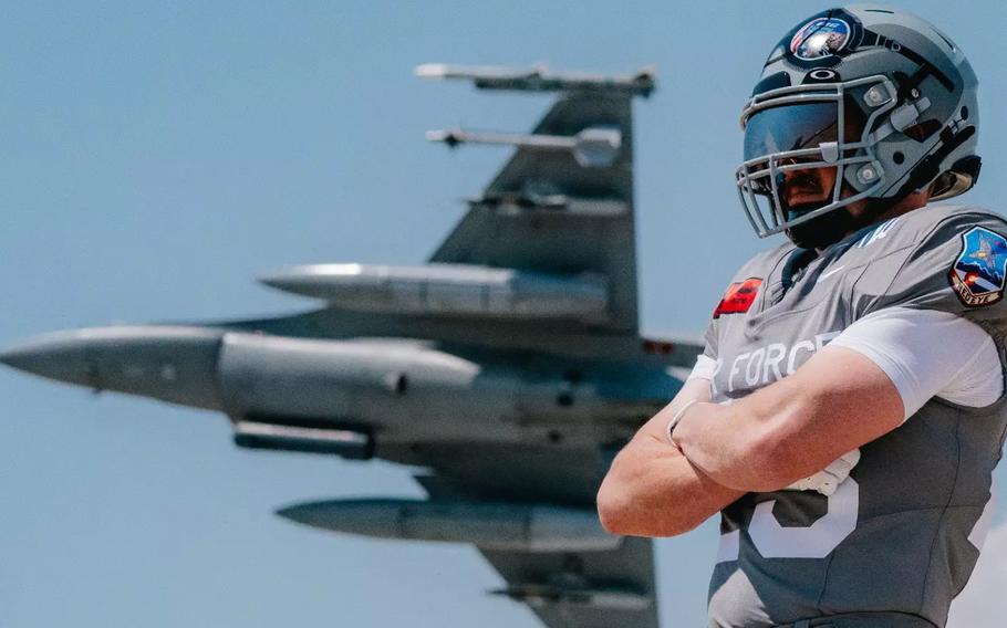 A football player in uniform with an image of an F-16 in flight in the background.