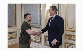 In this photo provided by the Ukrainian Presidential Press Office, Ukrainian President Volodymyr Zelenskyy, left, shakes hands with Britain's Foreign Secretary David Cameron in Kyiv, Ukraine, Thursday, May 2, 2024. (Ukrainian Presidential Press Office via AP)