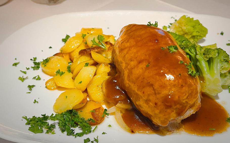 The rolled pork stuffed with cheese and peppers comes with steamed vegetables and country potatoes at Zur Pfaffschenke in Kaiserslautern, Germany. The eatery offers a large menu of German comfort food favorites.