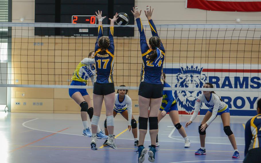 Sigonella’s Isabella Naselli spike the ball across the net as Ansbach Cougars Trinity Batin, left, and Kennedy Lange jump to block her shot during the 2022 DODEA-Europe Volleyball Tournament Oct. 29, 2022, at Ramstein Air Base, Germany.