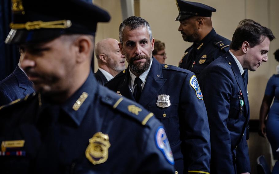 Michael Fanone prepares to depart after a congressional hearing.