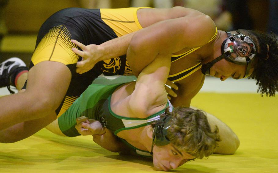 Kadena's Jeremiah Drummer gains the edge on Kubasaki's Ian Lyons at 180 pounds during Wednesday's Okinawa wrestling dual meet. Drummer won by technical fall 12-2 in 2 minutes, 25 seconds, but the Dragons took the meet 40-23.