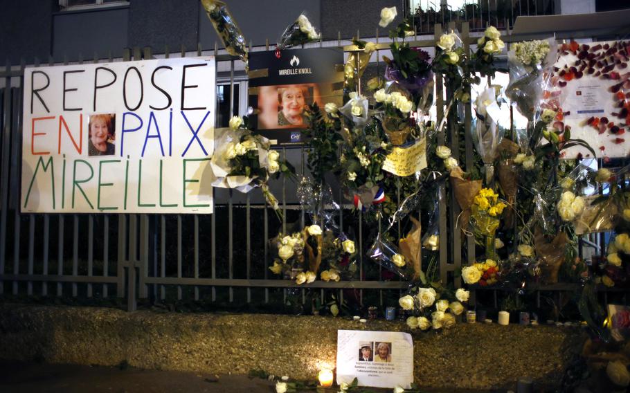 In this Wednesday, March 28, 2018 file photo, flowers and placards are displayed outside Mireille Knoll’s apartment during a silent march in Paris, France.