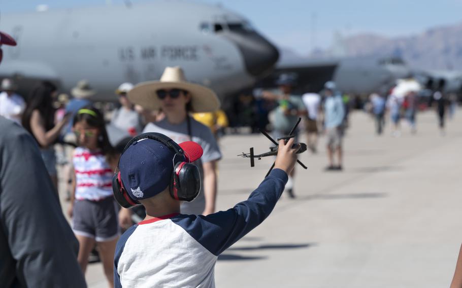 A young boy plays with a toy airplane