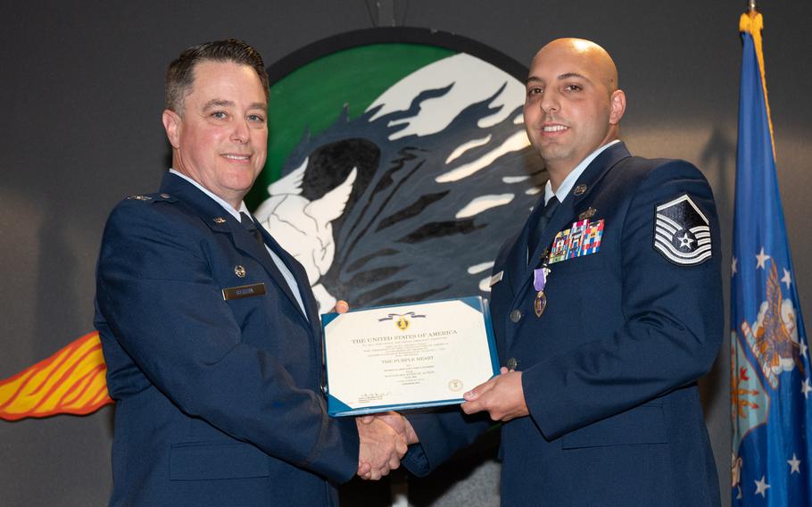 U.S. Air Force Colonel Jeremy Bergin, 27th Special Operations Wing commander, presents the Purple Heart to U.S. Air Force Master Sgt. Cory Engberg, 43d Intelligence Squadron Silent Shield Maintenance Production superintendent, during a ceremony, June 15, 2023, at Cannon Air Force Base, N.M. Engberg received the medal for wounds received in action during his deployment July 7, 2021, in support of the 16th Expeditionary Special Operations Squadron.