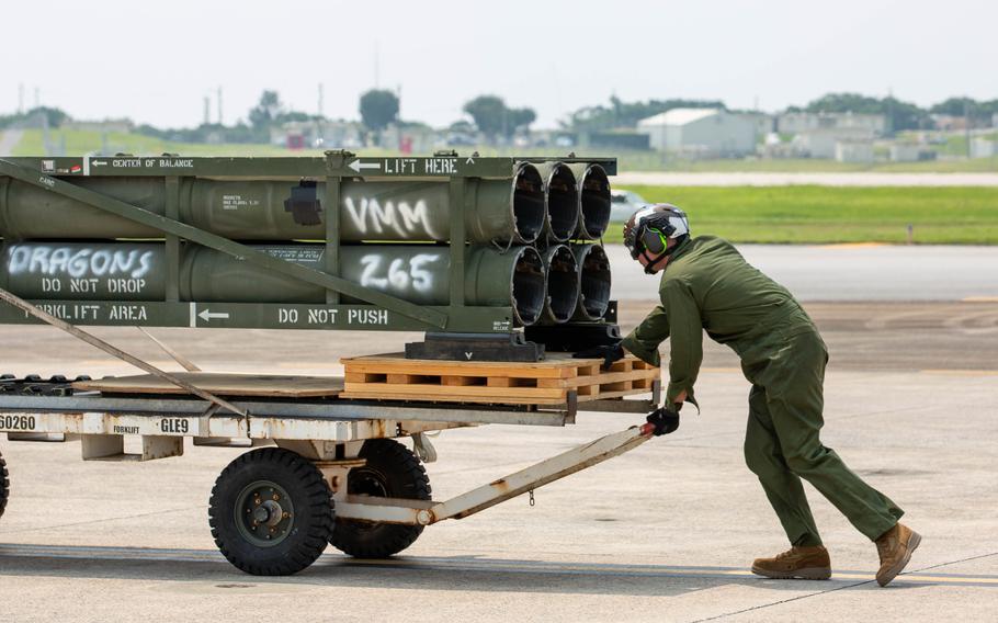 A Marine moves M142 High Mobility Artillery Rocket System (HIMARS) ammunition pods onto an MV-22B Osprey at Marine Corps Air Station Futenma, Okinawa, Japan, May 8, 2024.
