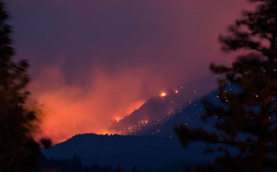 A wildfire burns above the Fraser River Valley near Lytton, British Columbia, Canada, on July 2, 2021.