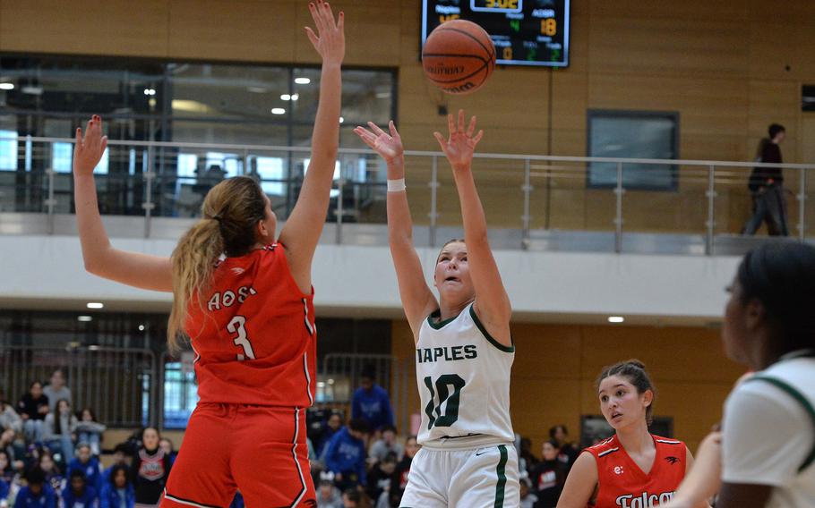 Naples’ Gracie Grannis takes a shot over AOSR defender Nina Neroni n the girls Division II final at the DODEA-Europe basketball championships in Wiesbaden, Germany, Feb. 17, 2024. Naples won the game 48-29.