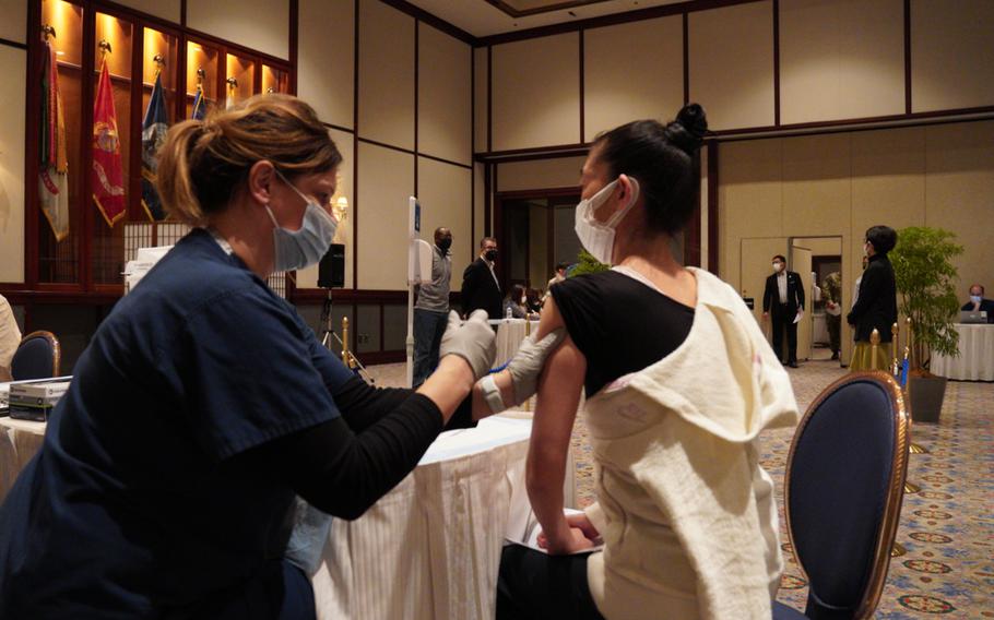 New Sanno Hotel receptionist Yoko Itagaki gets a COVID-19 vaccine at the U.S. military-run facility in central Tokyo, Wednesday, Feb. 16, 2022.