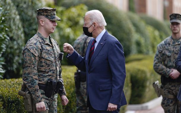 President Joe Biden visits a marine outside the Marine Barracks Washington, Tuesday, Jan. 25, 2022, in Washington. (AP Photo/Andrew Harnik)