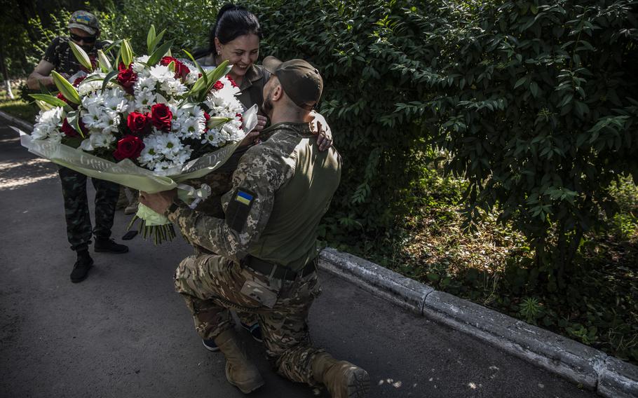 Mykola Kovtun, a Ukrainian soldier as he kneels down to propose marriage to Natalia Tkachenko, 32, during a surprise engagement celebration held at a hospital in the eastern Ukrainian city of Sloviansk on June 30, 2022. Tkachenko works as a military nurse.