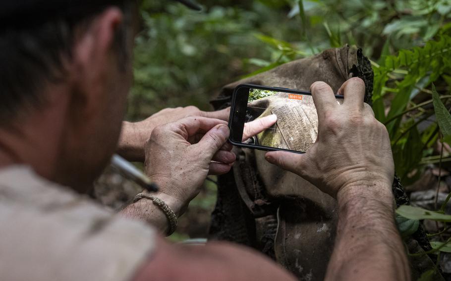 Steve Kleiman and Justin Taylan, director of Pacific Wrecks, document information May 16, 2024, on a radiator data plate on wreckage in Papua New Guinea from a P-38 plane once flown by World War II flying ace Richard Bong.