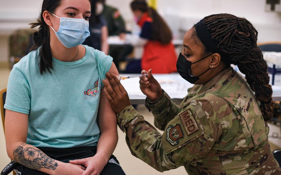 U.S. Air Force Tech. Sgt. Latasha Smith, right, 86th Operational Medical Readiness Squadron warrior medicine clinic flight chief, administers the Moderna COVID-19 booster shot to an airman at Ramstein Air Base, Germany, Jan. 28, 2022. A new COVID-19 booster shot targeting prevalent subvariants of the virus will be available to personnel in Europe this fall.  