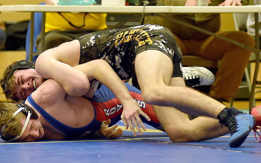Stuttgart's Zach Call holds Ramstein's Kydan Echard to the ground during the 144-pound title match at the Warrior Wraggle on Jan. 13, 2024, at Wiesbaden High School in Wiesbaden, Germany.