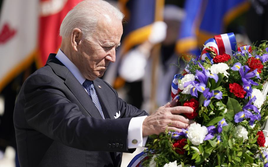President Joe Biden adjusts a wreath at the Tomb of the Unknown Soldier at Arlington National Cemetery on Memorial Day, Monday, May 31, 2021, in Arlington, Va.