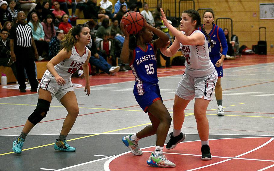 Raider Katya von Eicken pressures Ramstein's Bralyn Jones during a Dec. 14, 2023, game at Kaiserslautern High School in Kaiserslautern, Germany. Also coming to trap Jones is Kaiserslautern's Marisa Branch, left.