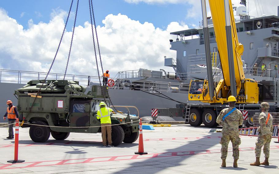 Soldiers and civilian contractors unload military vehicles from the Army vessel Lt. Gen. William B. Bunker at Naval Base Guam, July 10, 2021, in support of the Pacific Forager exercise.