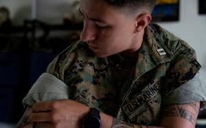 A Marine gets dressed.