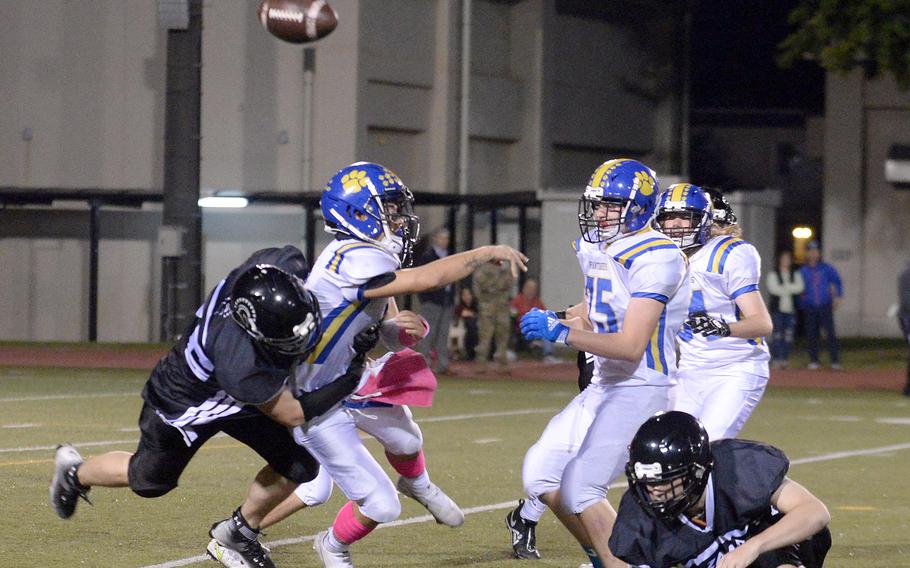 Yokota quarterback Dylan Tomas has the ball knocked out of his hand by Zama defender Kainoah Venn.