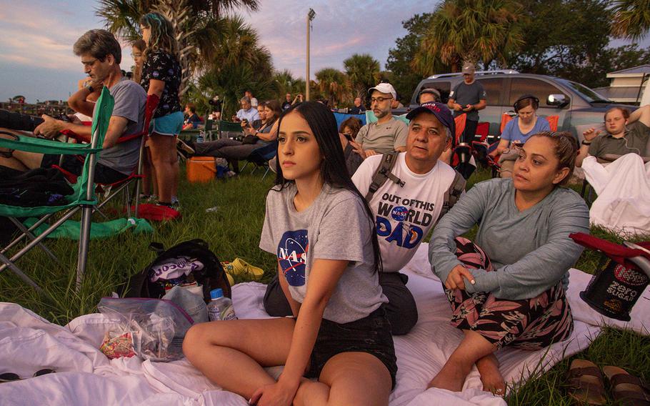 Joselyn Guerrero, 22, Alex Guerrero, 54 and Margo Castro, 51, of Costa Rica, await the launch of the Artemis rocket with others from Rotary Riverfront Park in Titusville on Aug. 29, 2022. NASA scrubbed the launch following an engine issue.