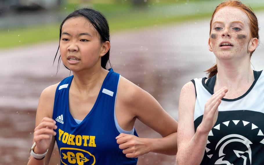 Yokota's Nikki Hsu and Zama's Avery Pilch run through the rain during Saturday's DODEA-Japan cross country race. Pilch placed eighth and Hsu ninth.