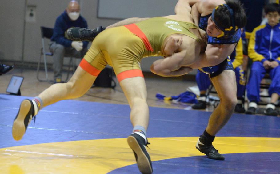 Yokota's Kaito Nelson tries to fend off St. Mary's Jiei Izukune at 141 pounds during Wednesday's Kanto Plain wrestling dual meet. Izukune pinned Nelson in 1 minute, 20 seconds and the Titans won the meet 46-5.