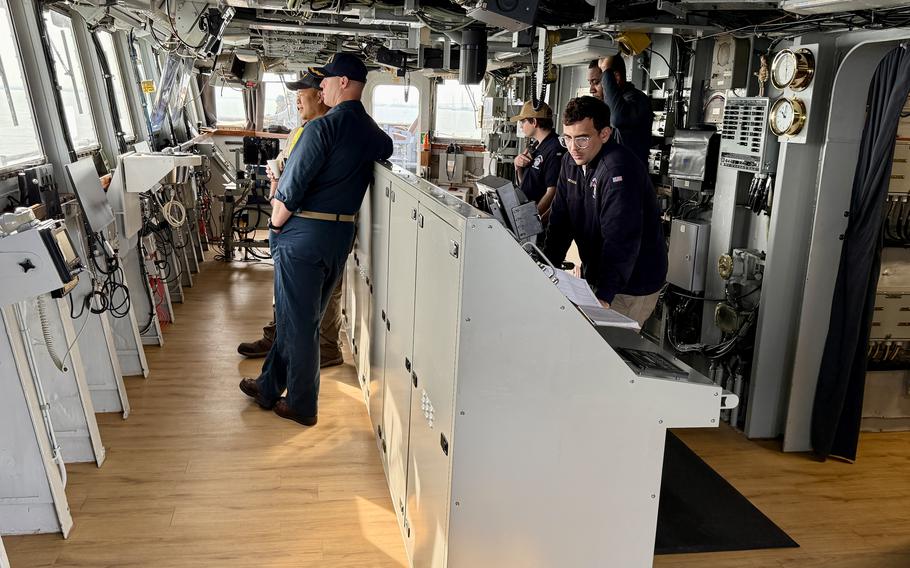 Sailors on board of the bridge of the USS Mount Whitney.