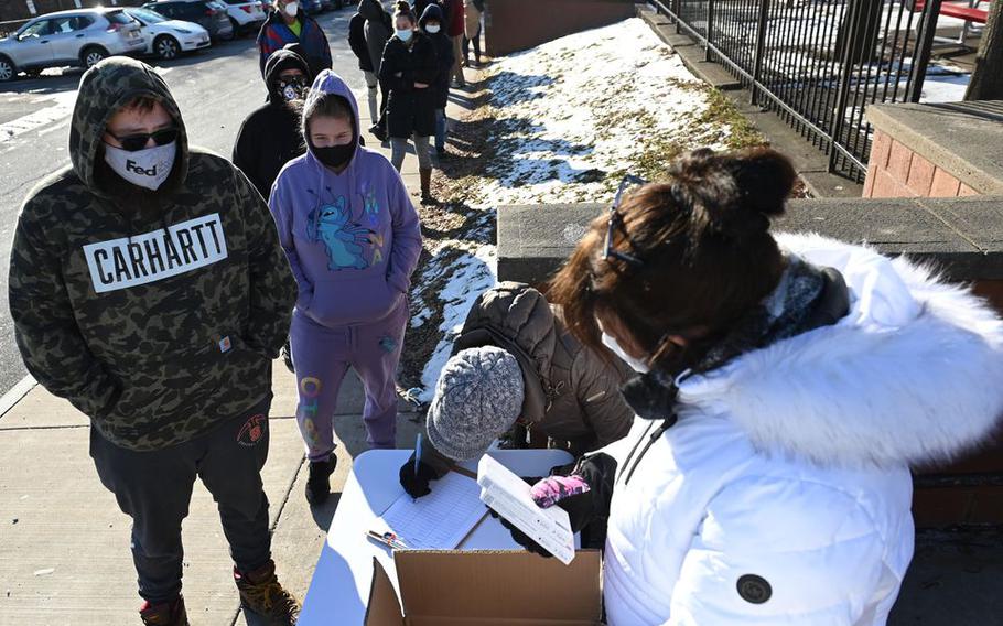 Syracuse residents line up outside the Northeast Community Center to get free home COVID tests Jan. 10, 2022.