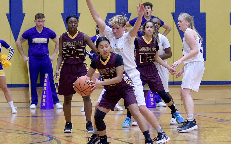Baumholder's Krisida Joy Fejeran, with ball, is bodied up by Wiesbaden's Mckinley Viers during Friday evening's game at Wiesbaden High School in Wiesbaden, Germany. Also in the photo are, from left, Buccaneers Adrianna Lopez and Alondra Aguillen, and Warrior Gren Icanberry.