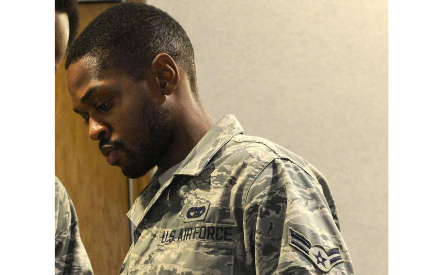 James Loubeau looks down in uniform 