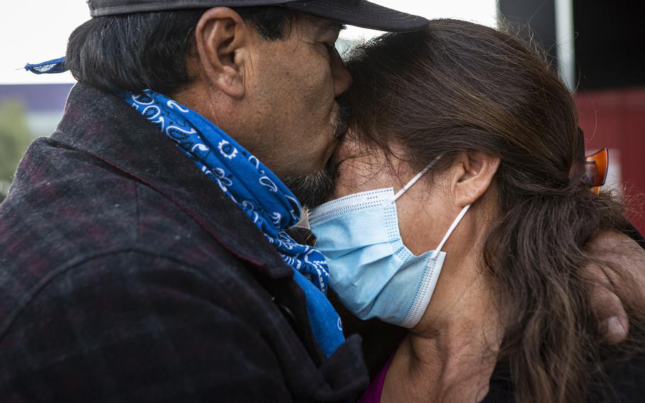 Andres Flores embraces his wife, Juana, at the airport in Tijuana on June 4 as she prepares to return to the United States. 