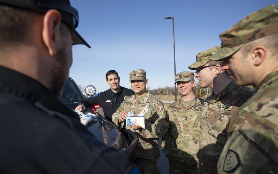 Alaska National Guardsman Sgt. 1st Class Oliver Meza (center), noncommissioned officer in charge of Drug Demand Reduction, trains Guard members and police officers in the use of naloxone kits provided through Project HOPE in Wasilla, Alaska, on April 13, 2022. The Alaska National Guard collaborates with the Office of Substance Misuse and Addiction Prevention in Project HOPE, a state-run initiative aimed at providing opioid overdose rescue kits and training mission partners and law enforcement agencies.