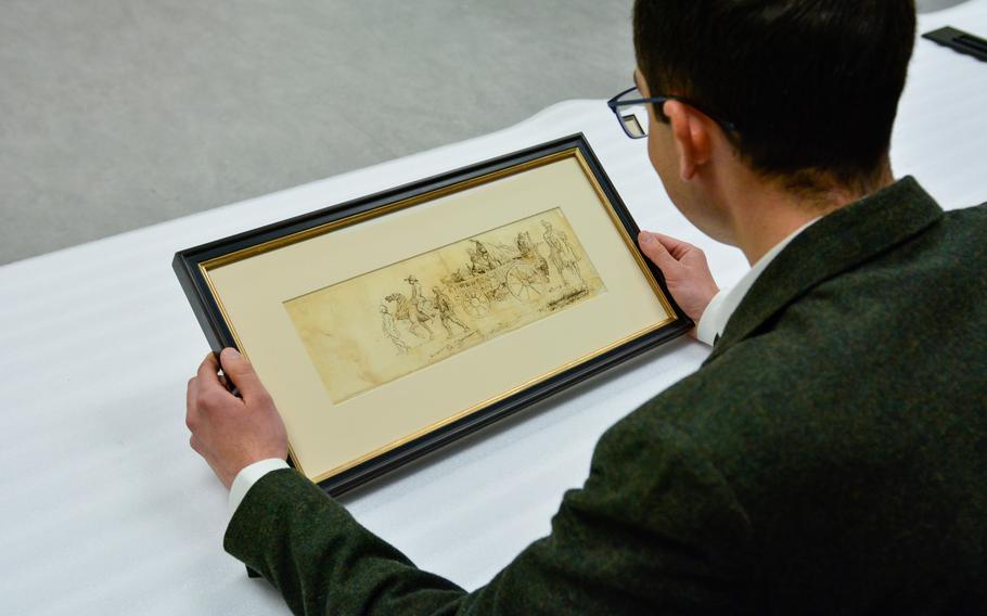 Matthew Skic examines the sketch by Pierre Eugene du Simitiere.
