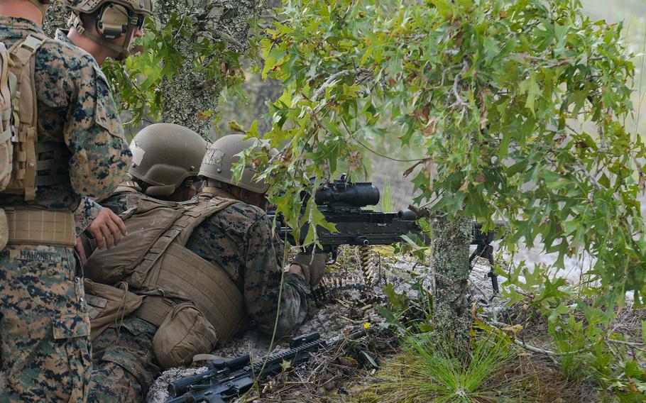 
Marine infantry students at Camp Lejeune, N.C., practice setting up an ambush, as their instructors look on, in a live-fire training event Aug. 27, 2021, during their 12th week of initial infantry training as part of a pilot program meant to drastically change the way the Corps trains its infantrymen. The pilot program expands infantry training from nine to 14 weeks and places Marines in 14-person squads under a single instructor. 
