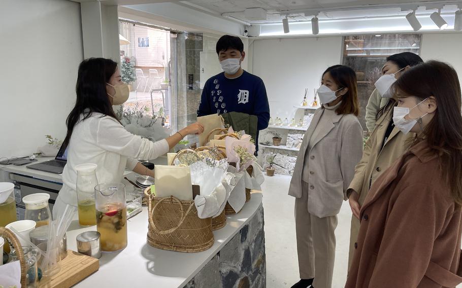 Customers receive their teas and baskets of flowers and stationery so they can take a break from daily life at “Green Lab” in Seoul, South Korea, on Nov. 19, 2021. 