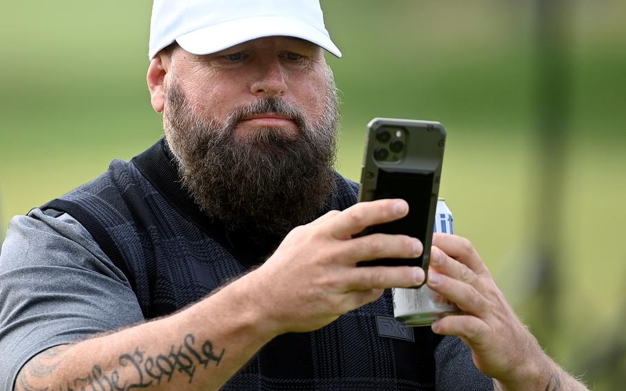 Marine veteran Chris Nowak records the scene at the PGA Hope event Monday at Congressional Country Club in Bethesda, Md. PGA Hope has specialized golf programs for veterans dealing with PTSD, brain injuries or other issues.