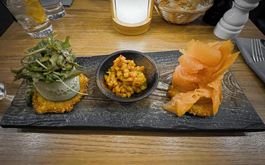 Norwegian smoked salmon atop a hash brown at Alte Post in Neckarsulm, Germany, Dec. 20, 2023, complemented by pumpkin zucchini chutney and an arugula salad.