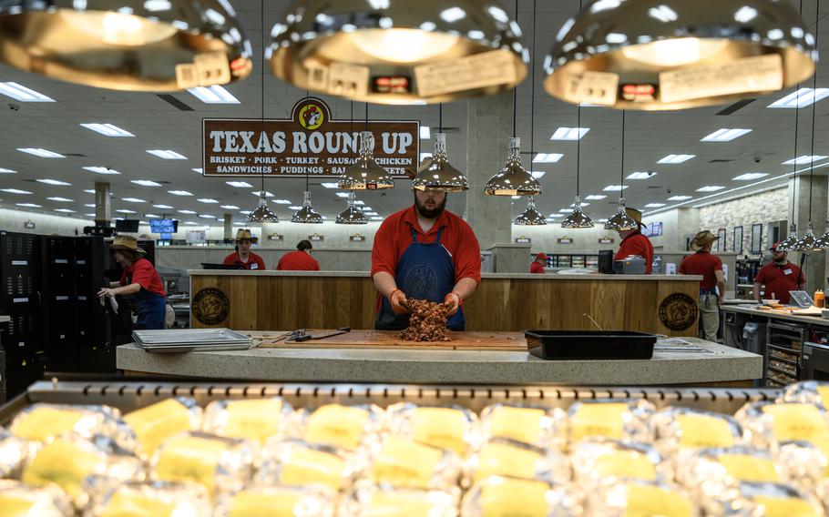 Sauce is mixed in with the fresh smoked brisket at the Texas Round Up station at what is currently the nation’s largest Buc-ee’s, in Sevierville, Tenn.