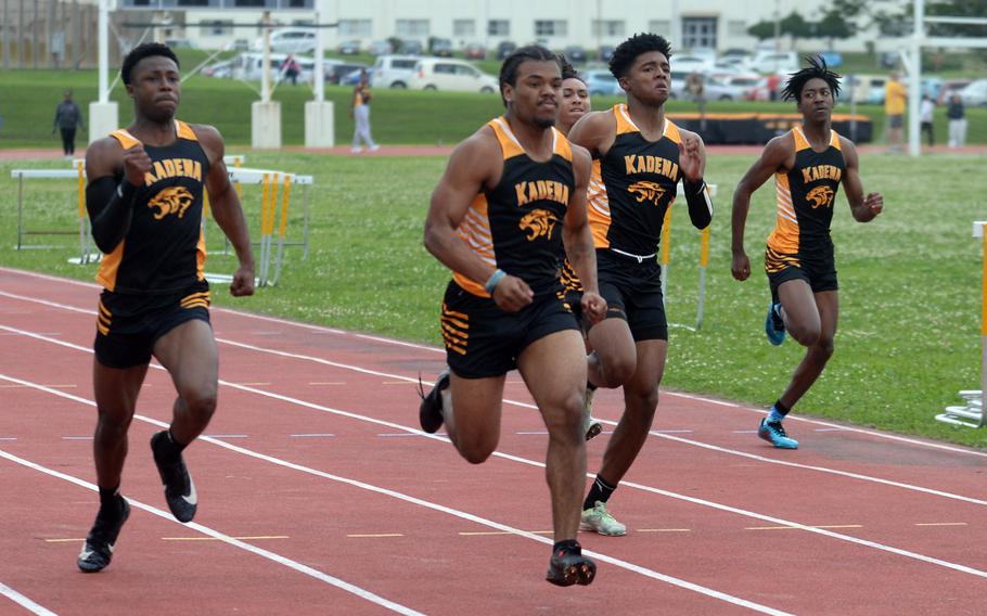 Kadena's D'Kylan Woods, middle, won the 100 in 11.08 seconds during Tuesday's Okinawa track and field meet.