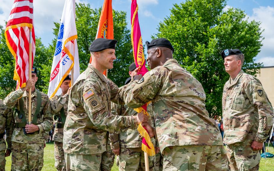 Col. Daniel Horn, left, assumes command of Tobyhanna Army Depot on June 28, 2021, as Maj. Gen. Mitchell Kilgo passes the flag.
