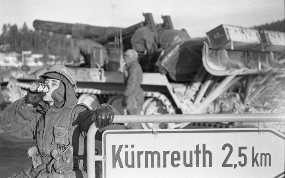 A soldier transporting a large cannon takes a coke break on the road to Kuermreuf, near the village of Sorghof, in the Vilseck-Grafenwoehr area. Troops taking part in the multi-day Carbide Ice exercise have been rolling through the area.