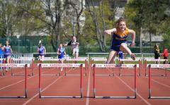 Track stand-out Ava Stout of the Wiesbaden Warriors, takes the last hurdle to the win at the Kaiserslautern Track and Field Invitational April 16, 2022, in Kaiserslautern, Germany. Stout won both the 100 and 300-meter hurdle heats.