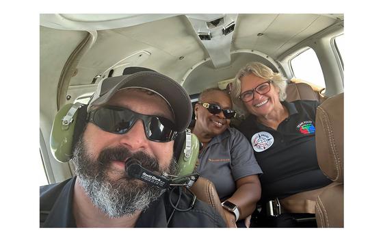 Bryan Stern, who leads the nonprofit group Project Dynamo, takes a photo with two Florida-based missionaries, Linotte Joseph, left, and Miriam Cinotti, while being rescued from Haiti. 