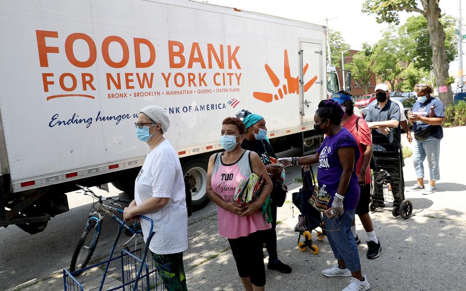 In this photo from June 19, 2021, Queens community members line up to receive food from Food Bank for New York City  at Deliverance Baptist Church in Cambria Heights, N.Y.